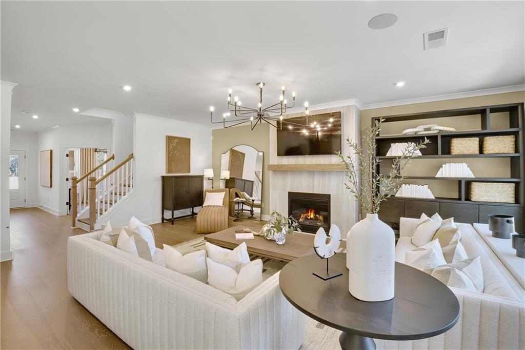 a living room with fireplace a dining table and a fireplace