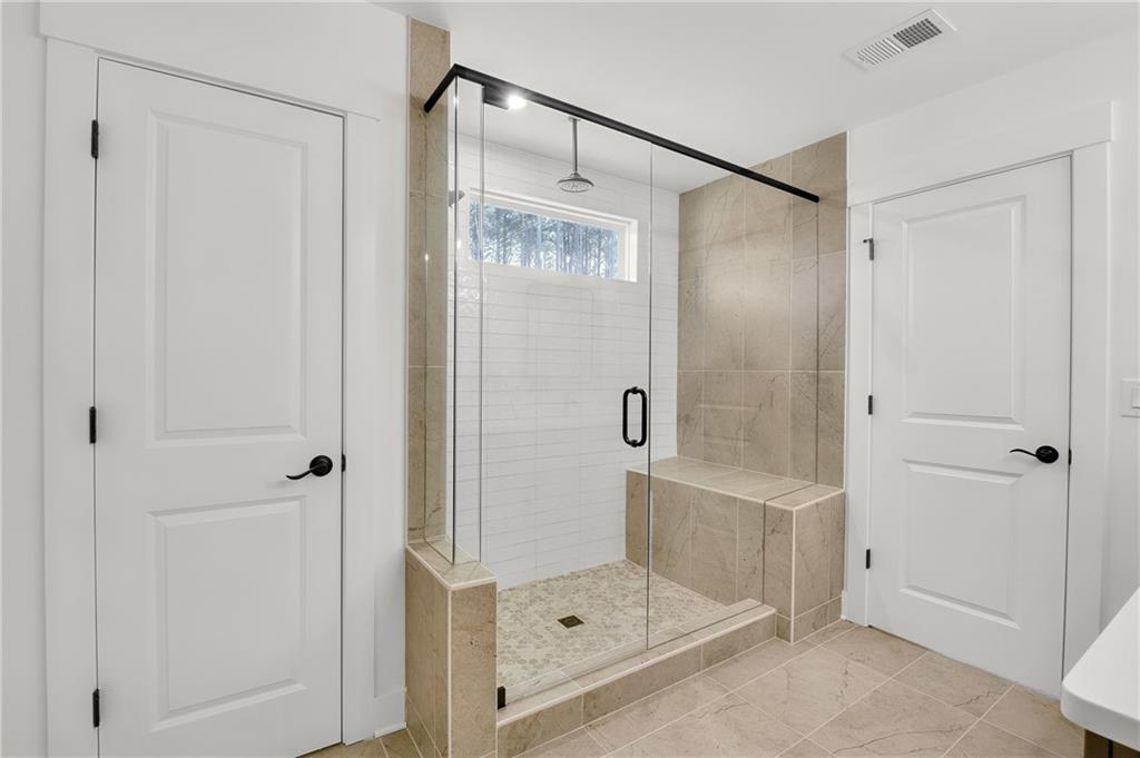 251 Rockledge Bend Powder Springs, GA 30127 - Photo 13 of 23 a bathroom with a glass shower door
