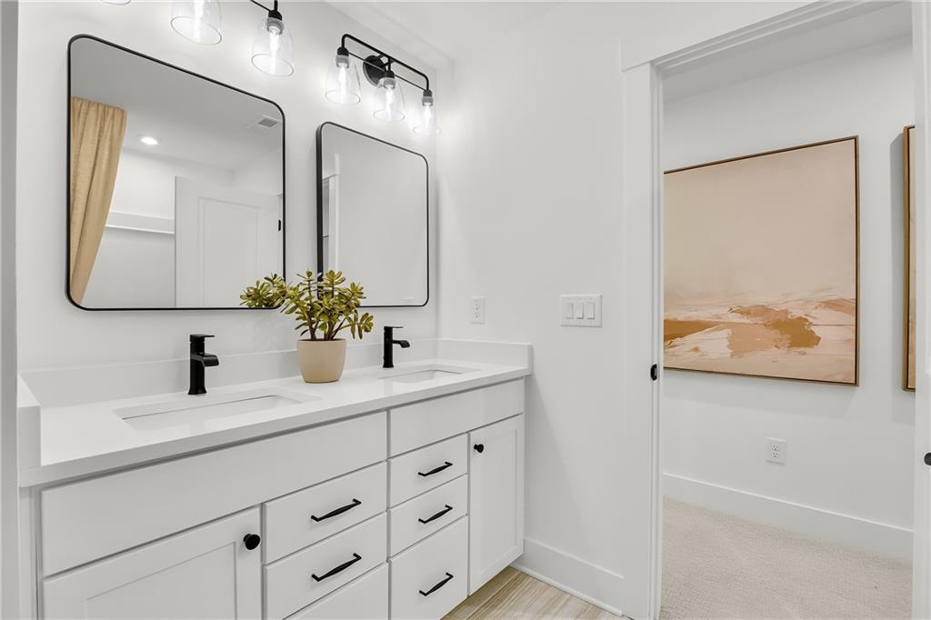 251 Rockledge Bend Powder Springs, GA 30127 - Photo 17 of 23 a bathroom with a double vanity sink and a mirror