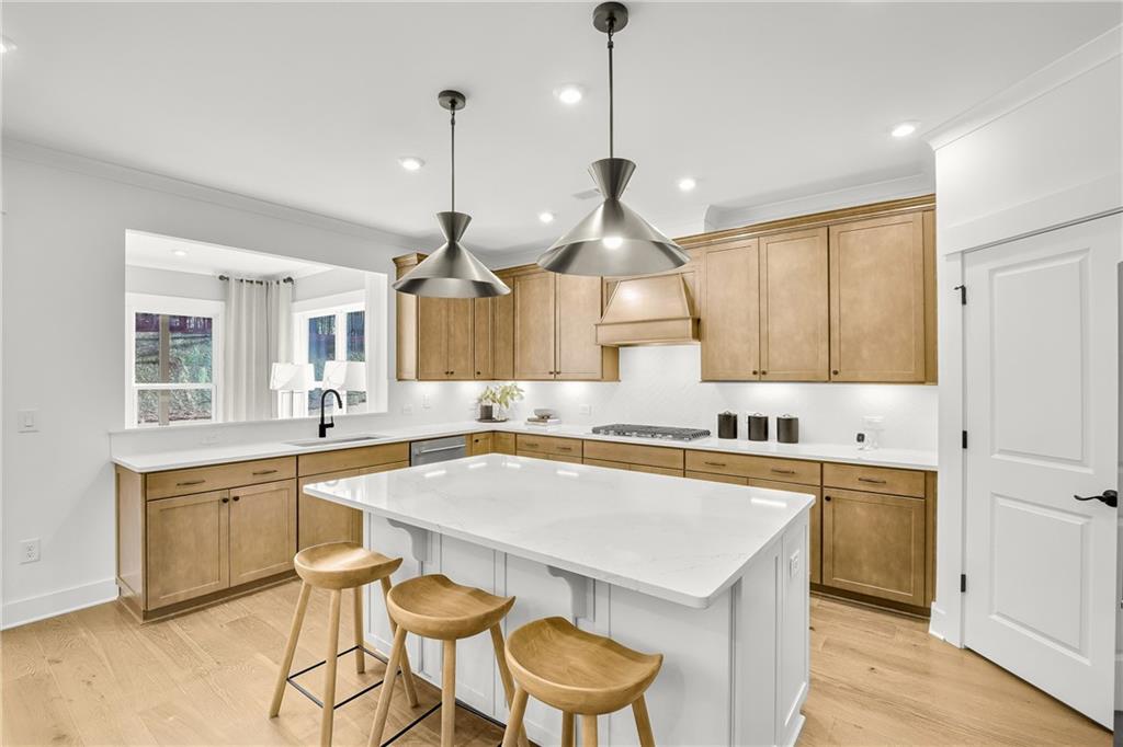 251 Rockledge Bend Powder Springs, GA 30127 - Photo 4 of 23 a kitchen with a stove a sink a table and chairs