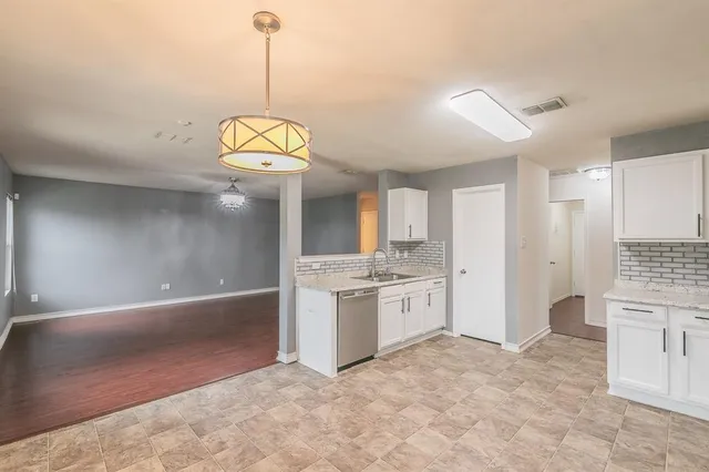 a view of a kitchen with a sink and cabinets