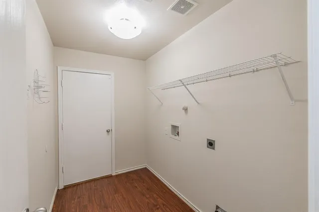 a view of a room with wooden floor and fan