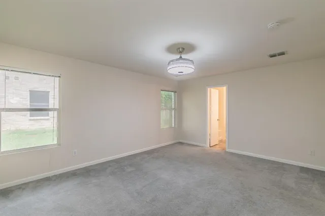 an empty room with windows and entrance