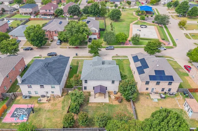 an aerial view of multiple houses with yard