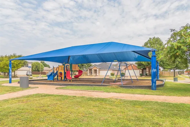 a view of yard with swimming pool and sitting area