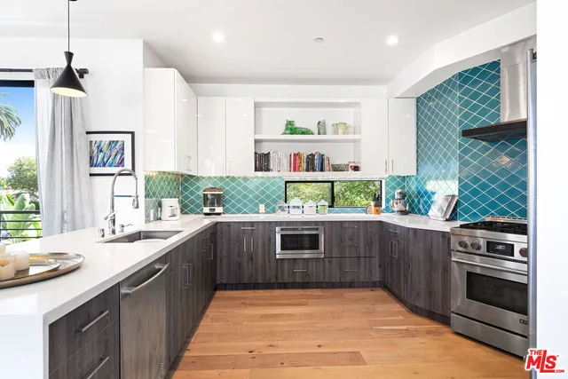 a kitchen with stainless steel appliances granite countertop a sink and stove