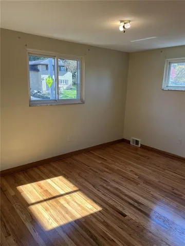 a view of an empty room and wooden floor