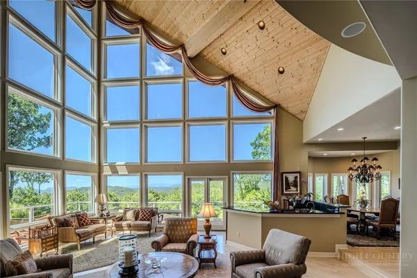 a living room with furniture and large windows