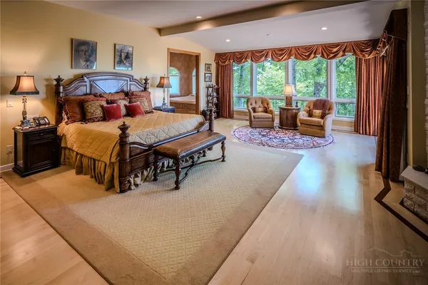 a living room with furniture a fireplace and a floor to ceiling window