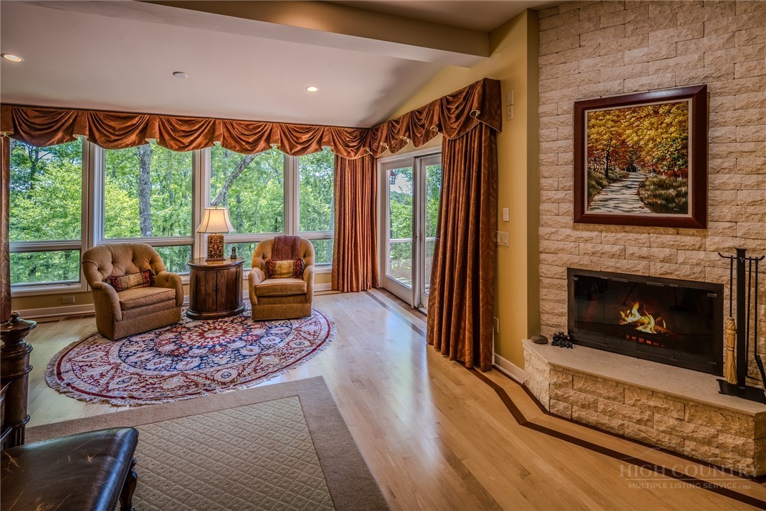 331 Branch Water Run Linville, NC 28646 - Photo 24 of 50 a living room with furniture a fireplace and a floor to ceiling window