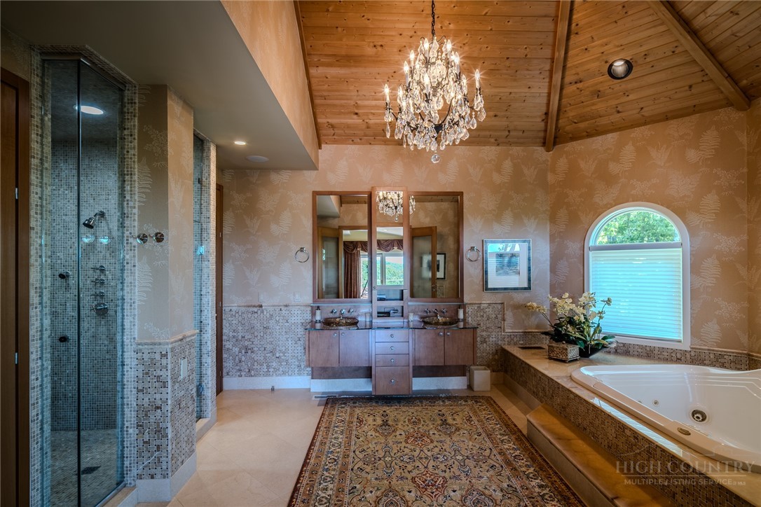 331 Branch Water Run Linville, NC 28646 - Photo 26 of 50 a large spacious bathroom with a granite countertop tub a mirror and a shower
