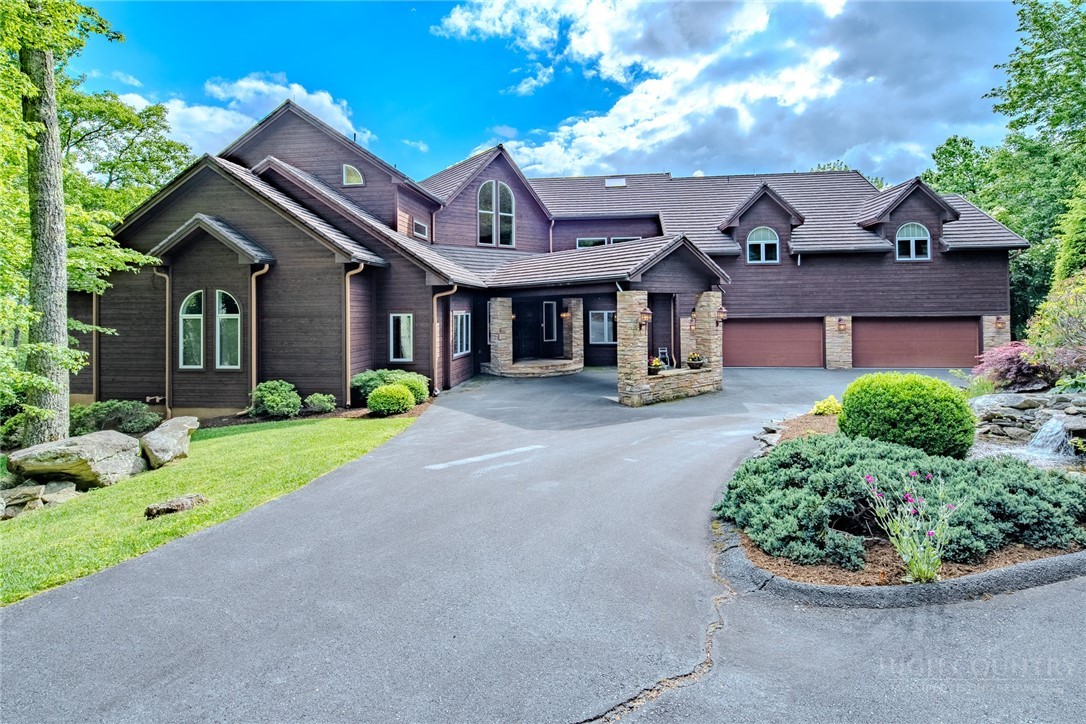 331 Branch Water Run Linville, NC 28646 - Photo 3 of 50 a front view of a house with a garden and plants