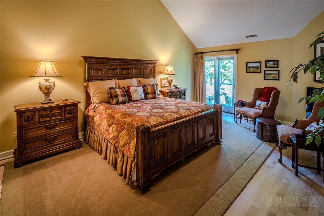 331 Branch Water Run Linville, NC 28646 - Photo 35 of 50 a bed sitting in a bedroom next to a window with lamp