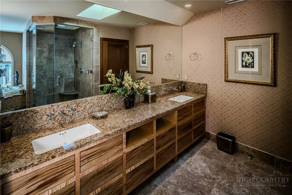a living room with furniture chandelier and a fireplace