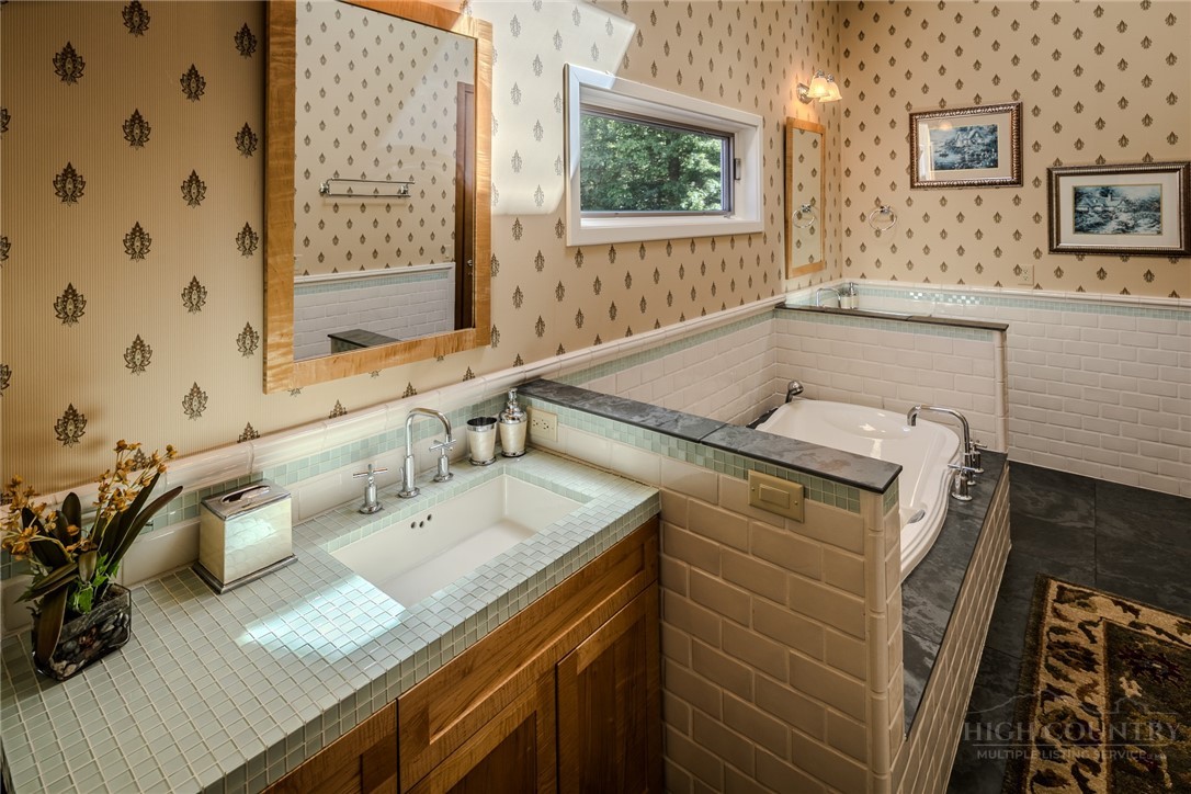 331 Branch Water Run Linville, NC 28646 - Photo 39 of 50 a bathroom with a granite countertop sink and a mirror