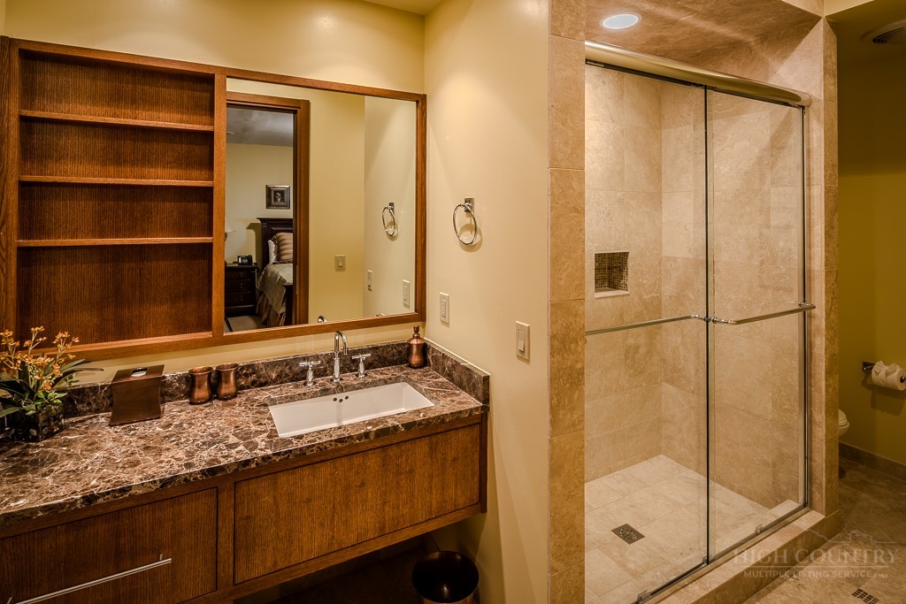 331 Branch Water Run Linville, NC 28646 - Photo 45 of 50 a bathroom with a granite countertop sink and a mirror