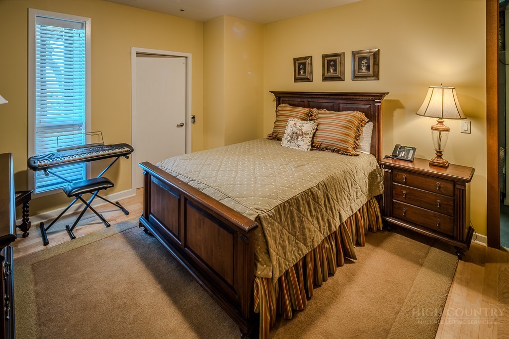 331 Branch Water Run Linville, NC 28646 - Photo 46 of 50 a bedroom with a bed and a night stand next to a window