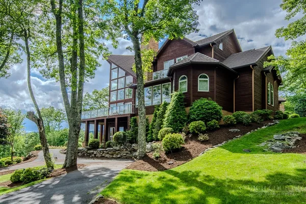 a front view of houses with yard and green space
