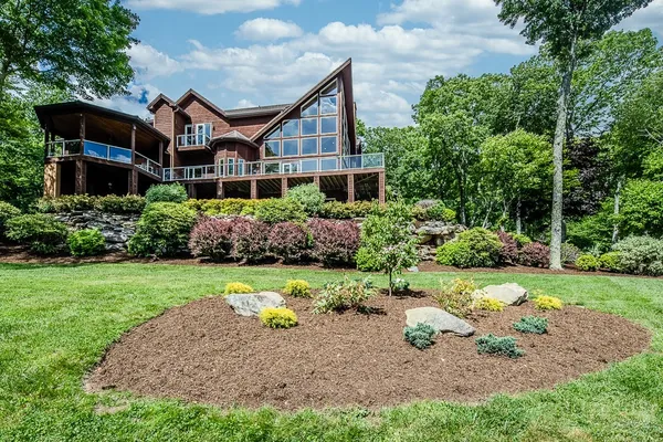 a aerial view of a house next to a yard