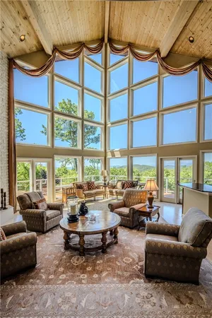 a living room with furniture and large windows