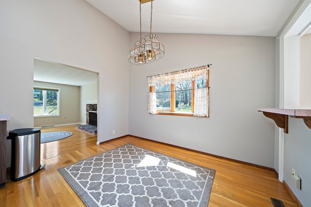 61 Orchard Road Marshfield, MA 02050 - Photo 12 of 33 a view of an empty room with window and wooden floor
