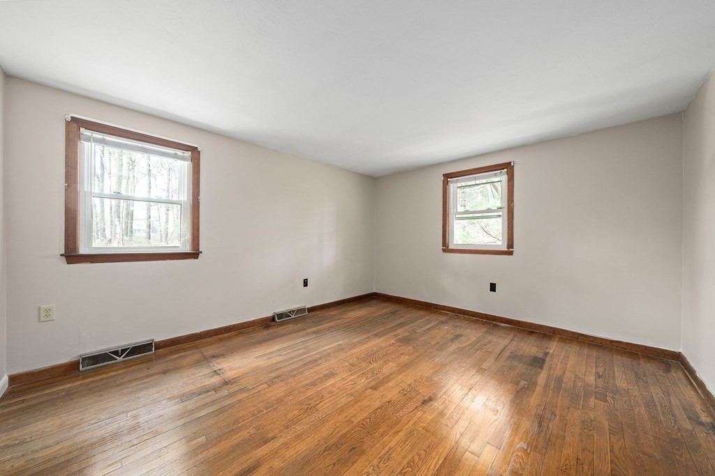 61 Orchard Road Marshfield, MA 02050 - Photo 20 of 33 a view of an empty room with wooden floor and a window