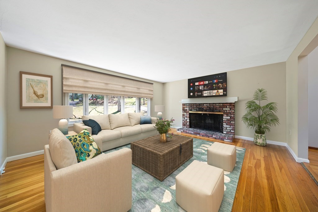 61 Orchard Road Marshfield, MA 02050 - Photo 2 of 33 a living room with furniture a fireplace and a flat screen tv