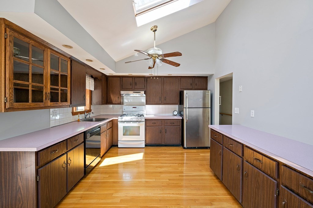 61 Orchard Road Marshfield, MA 02050 - Photo 7 of 33 a kitchen with stainless steel appliances granite countertop a sink a stove and refrigerator