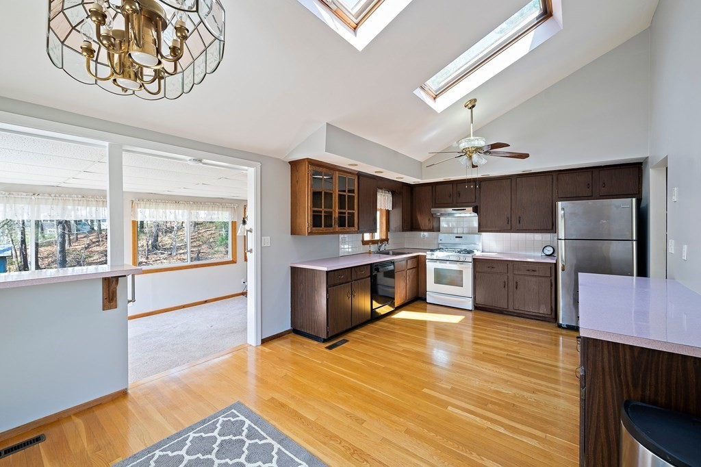 61 Orchard Road Marshfield, MA 02050 - Photo 9 of 33 a large kitchen with a stove cabinets and wooden floor