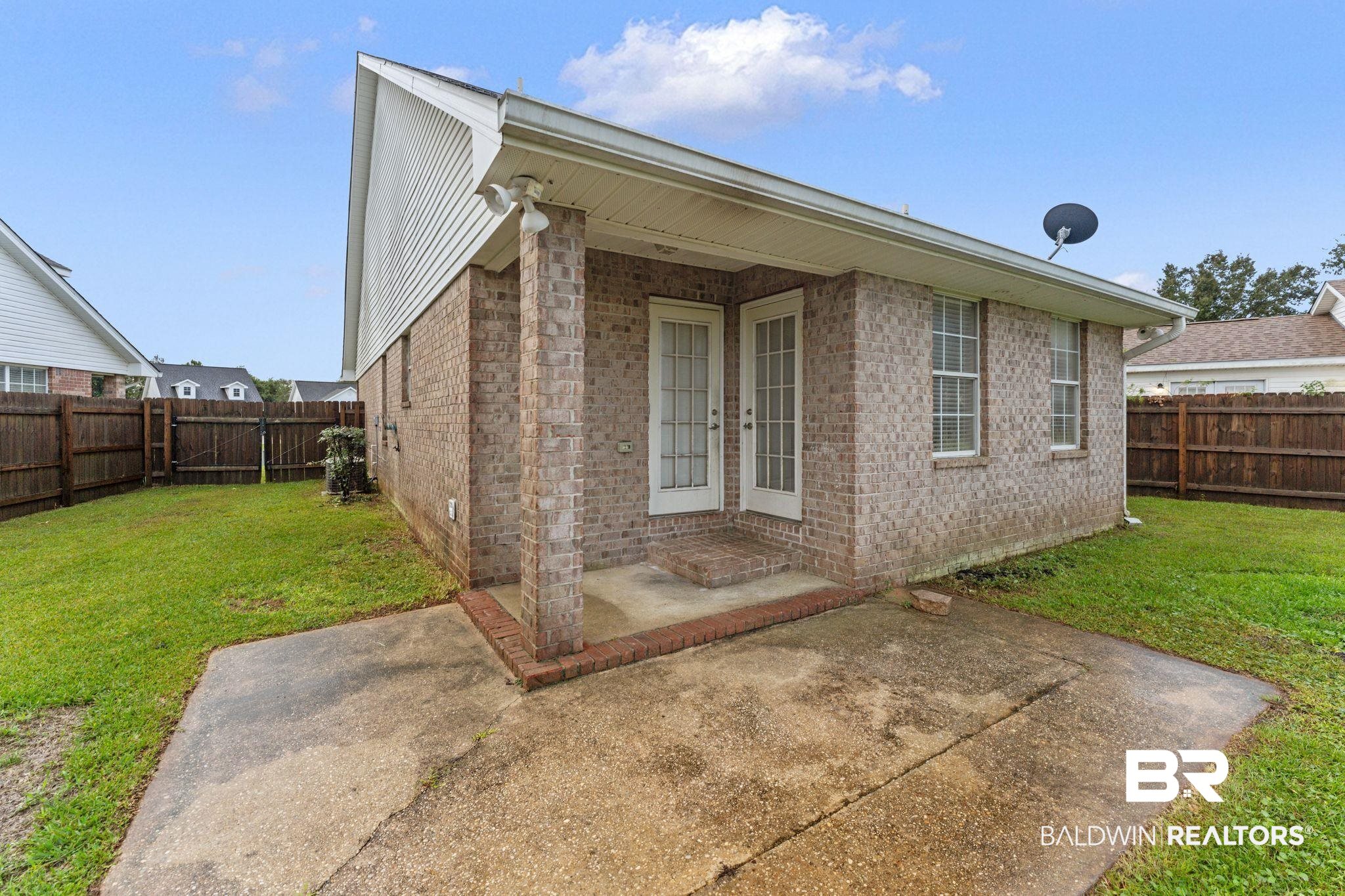 4009 Kendallbrook Loop Foley, AL 36535 - Photo 24 of 28 Rear view of house with a patio, brick siding, and a fenced backyard