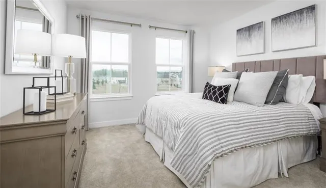 a bedroom with bed and window