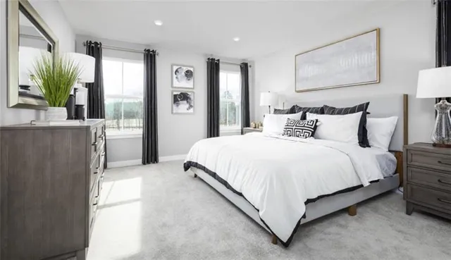 a bedroom with a bed and a painting on the wall