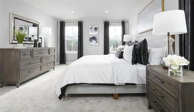 a spacious bedroom with a bed and dresser