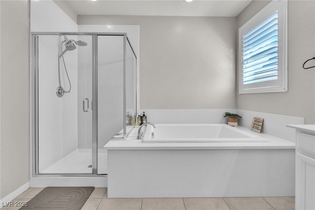119 Mosso Niente Place Henderson, NV 89011 - Photo 16 of 36 Bathroom featuring a garden tub, a shower stall, vanity, and light tile patterned floors