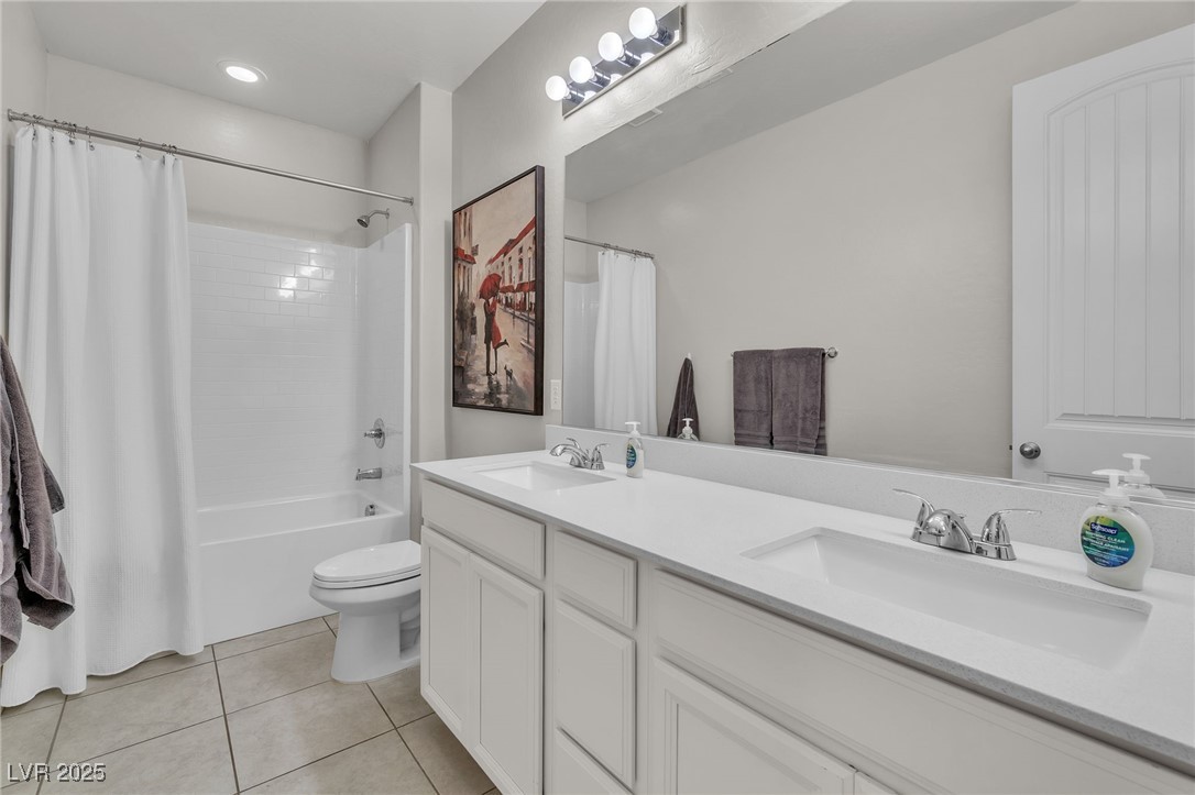 119 Mosso Niente Place Henderson, NV 89011 - Photo 21 of 36 Bathroom featuring shower / bathtub combination with curtain, double vanity, light tile patterned floors, and recessed lighting