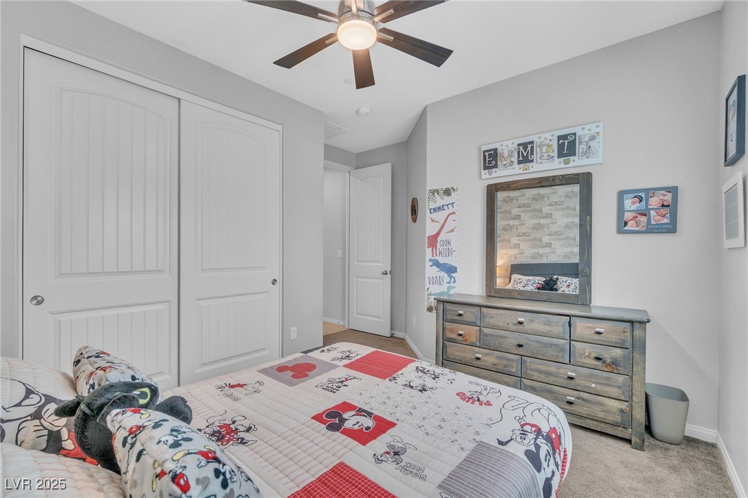 119 Mosso Niente Place Henderson, NV 89011 - Photo 27 of 36 Bedroom featuring a closet, light colored carpet, and ceiling fan