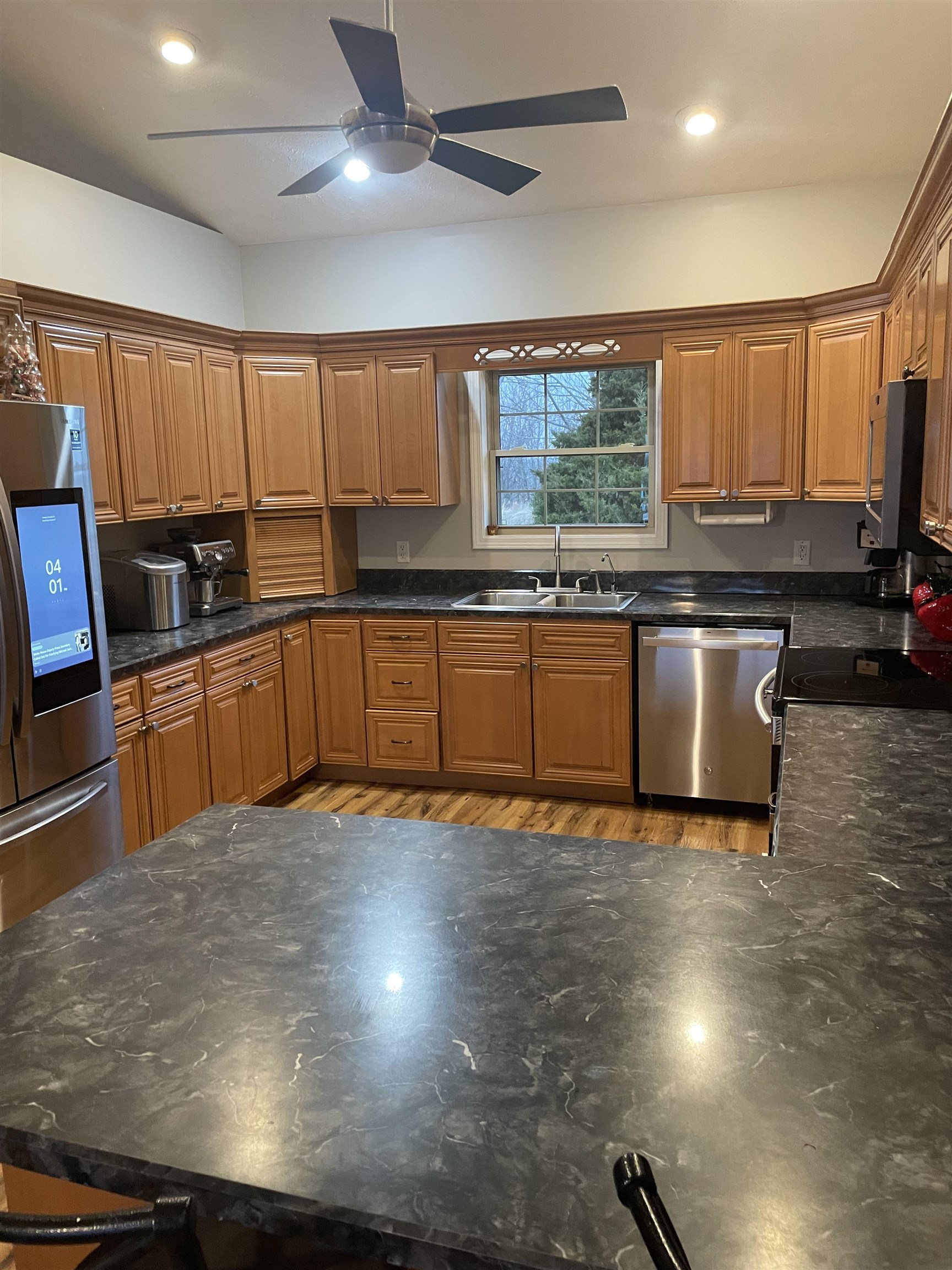 5488 Tick Ridge Road Grand Chain, IL 62941 - Photo 9 of 27 a view of a kitchen with kitchen island a large counter space a sink and appliances