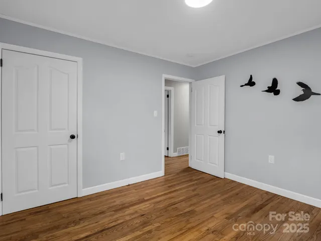 a view of a room with wooden floor