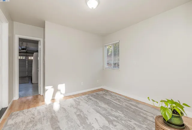 a view of a bedroom with wooden floor