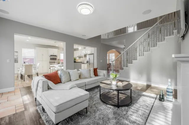 a living room with furniture and a potted plant