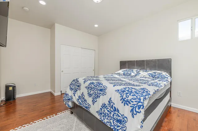 a bed sitting in a room next to a window