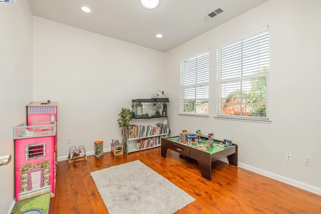 a spacious bathroom with a tub sink and mirror