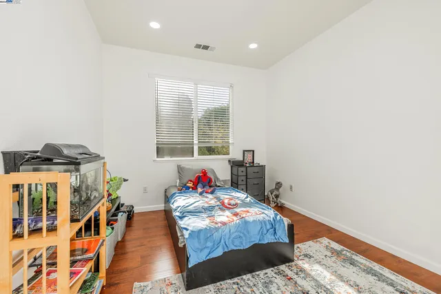 a bathroom with a sink a toilet a mirror and shower
