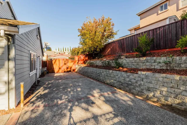 a view of a chairs and tables in the back yard of the house