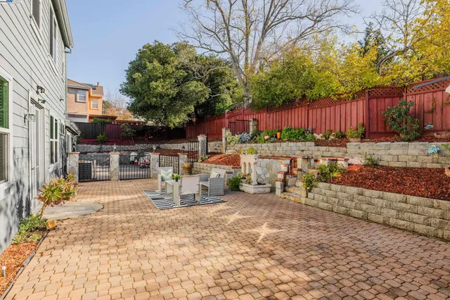 a view of a patio with table and chairs and potted plants