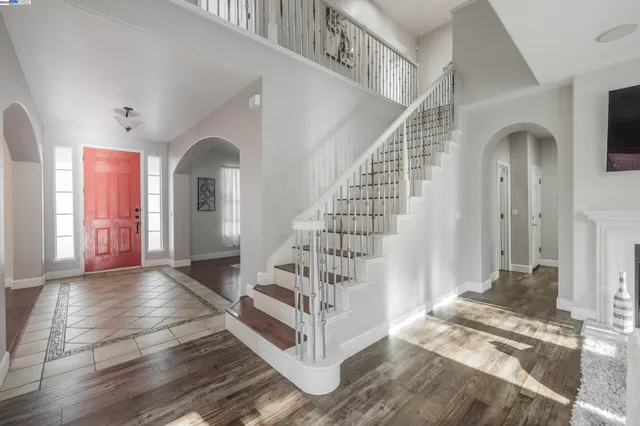 a view of entryway with hall and wooden floor