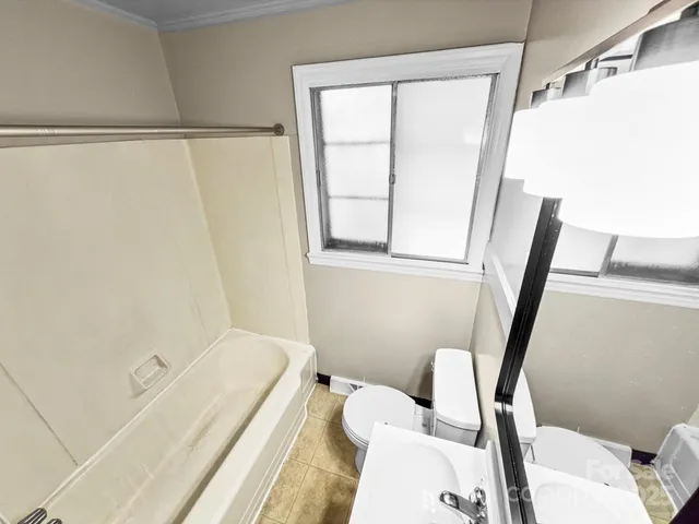 a bathroom with a tub and a window