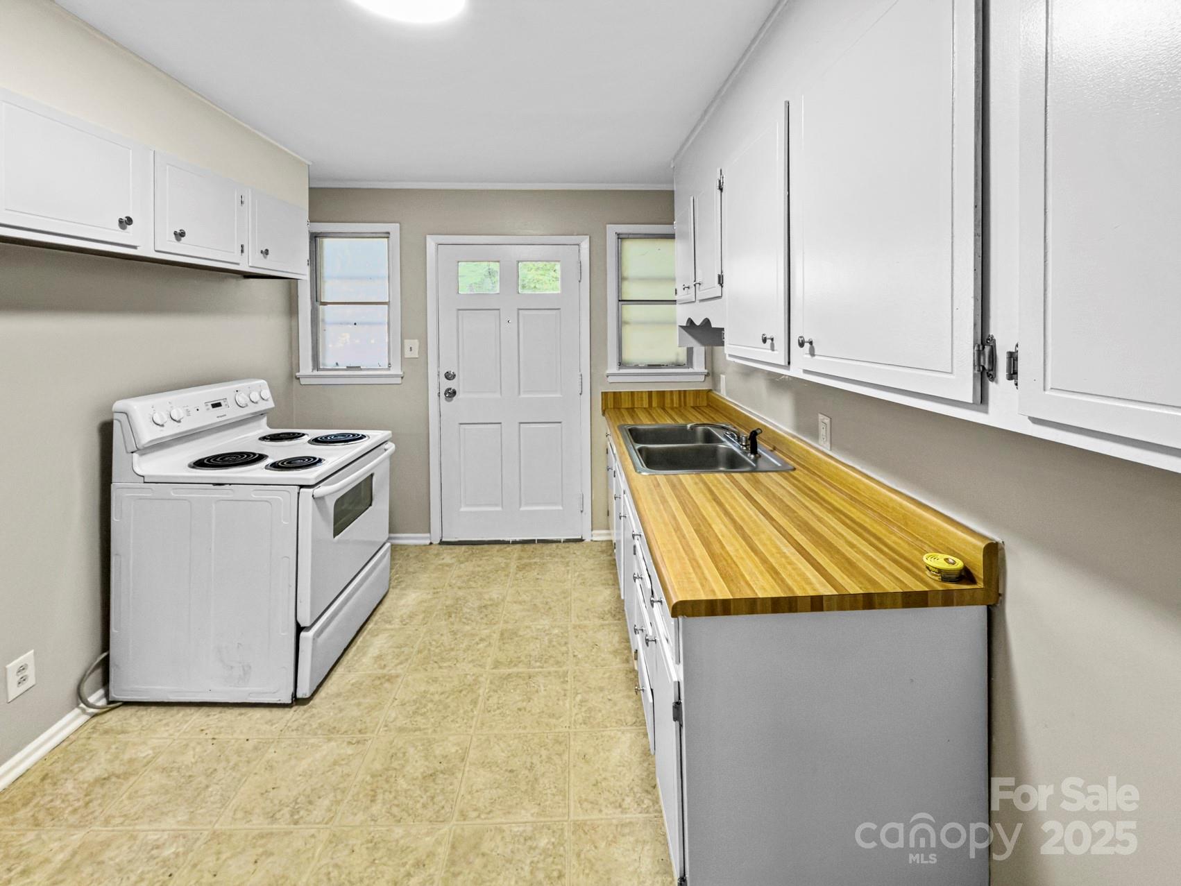 3014 Marlborough Road Charlotte, NC 28208 - Photo 17 of 20 a kitchen with granite countertop white cabinets and white appliances