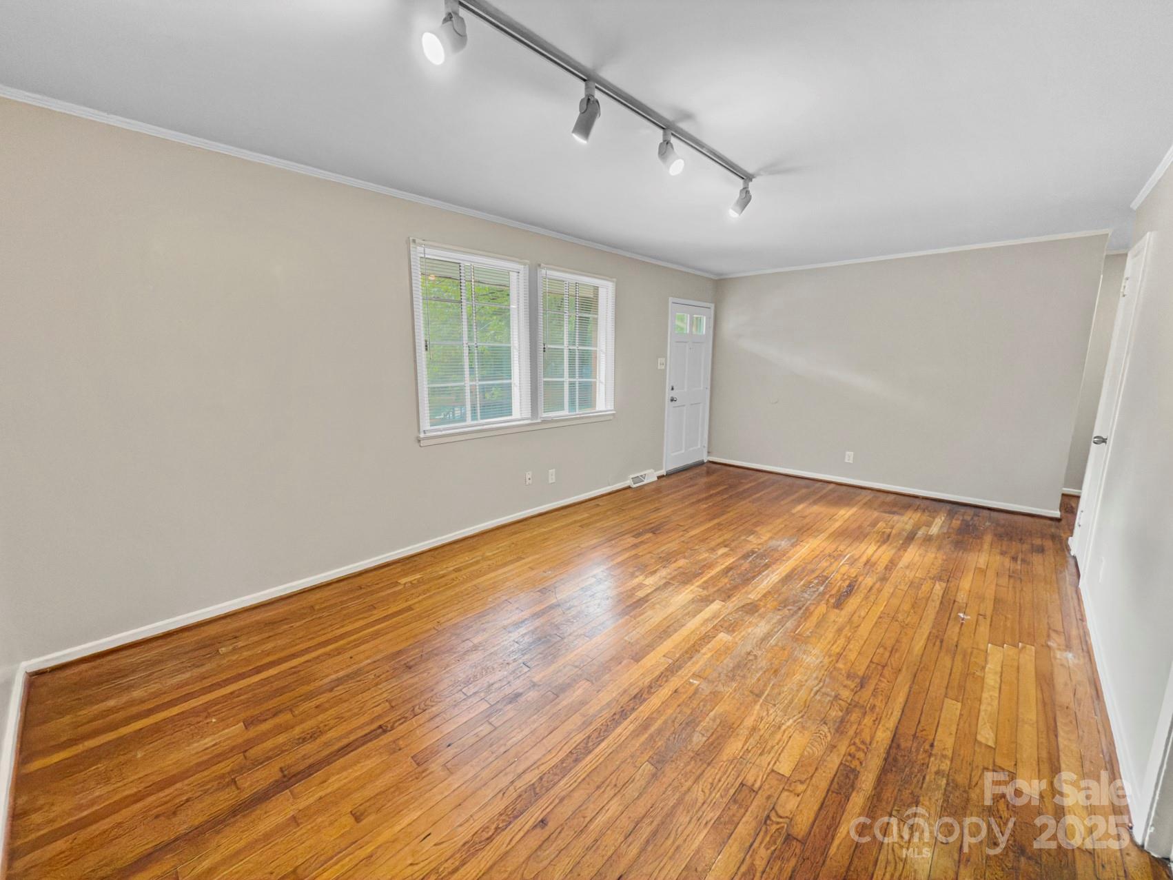 3014 Marlborough Road Charlotte, NC 28208 - Photo 2 of 20 a view of empty room with wooden floor and fan