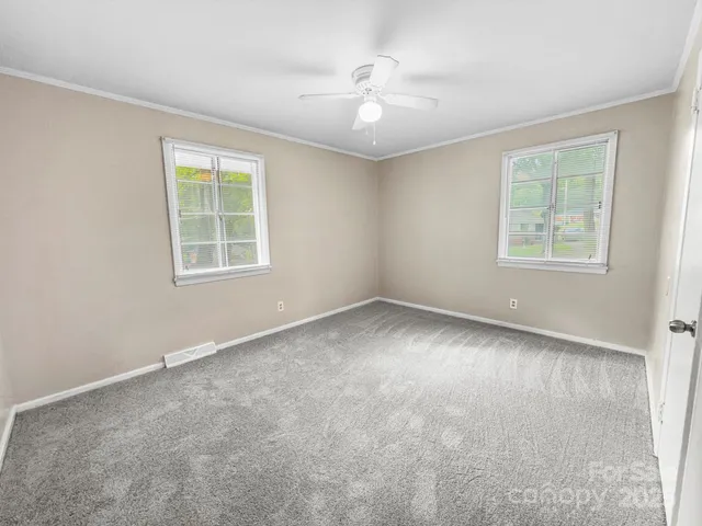 an empty room with windows and closet